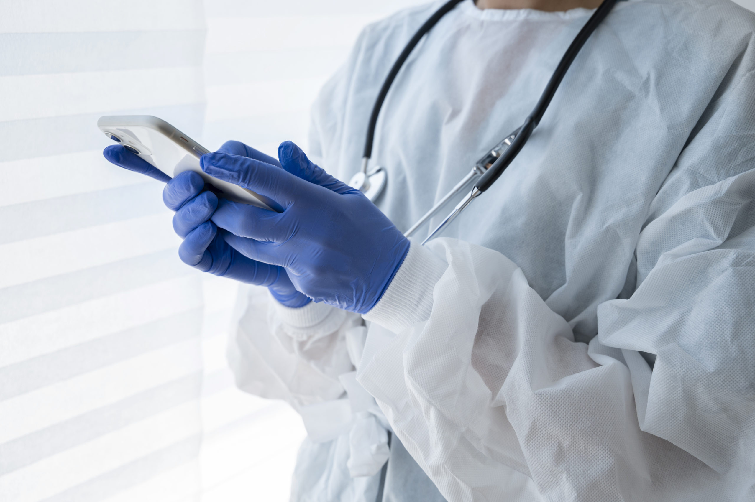 side-view-doctor-holding-smartphone Clinicgram | How AI is Transforming Wound Prevention